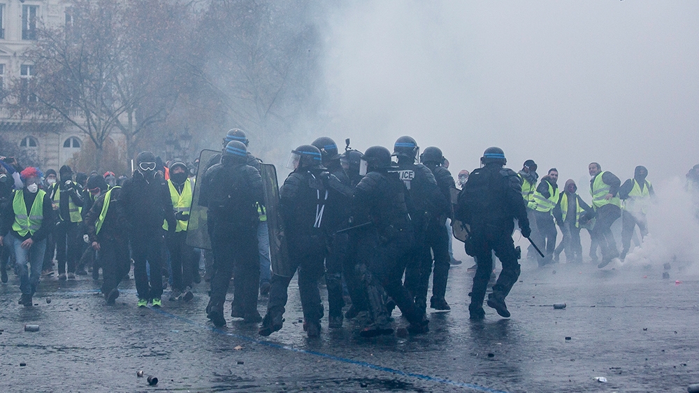 French police officers responded with tear gas, after demonstrators hurled stones and projectiles towards them [Omar Havana/Al Jazeera]