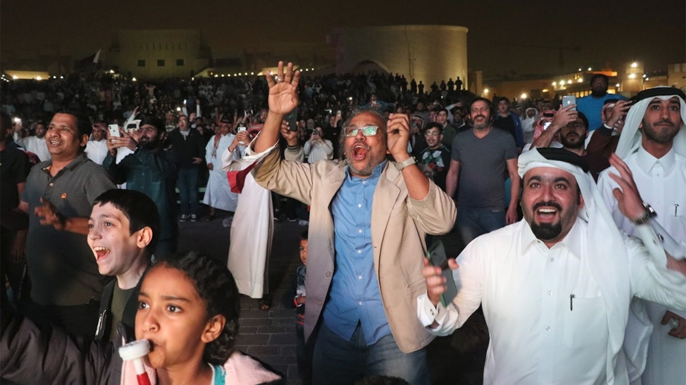 Qatar football fans celebrate the team's success in Doha [Huthifa Fayyad/Al Jazeera]