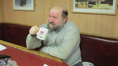 James Hellewell drinks tea in the galley of the Crystal Sea trawler in Newlyn harbour [Gavin O'Toole/Al Jazeera]