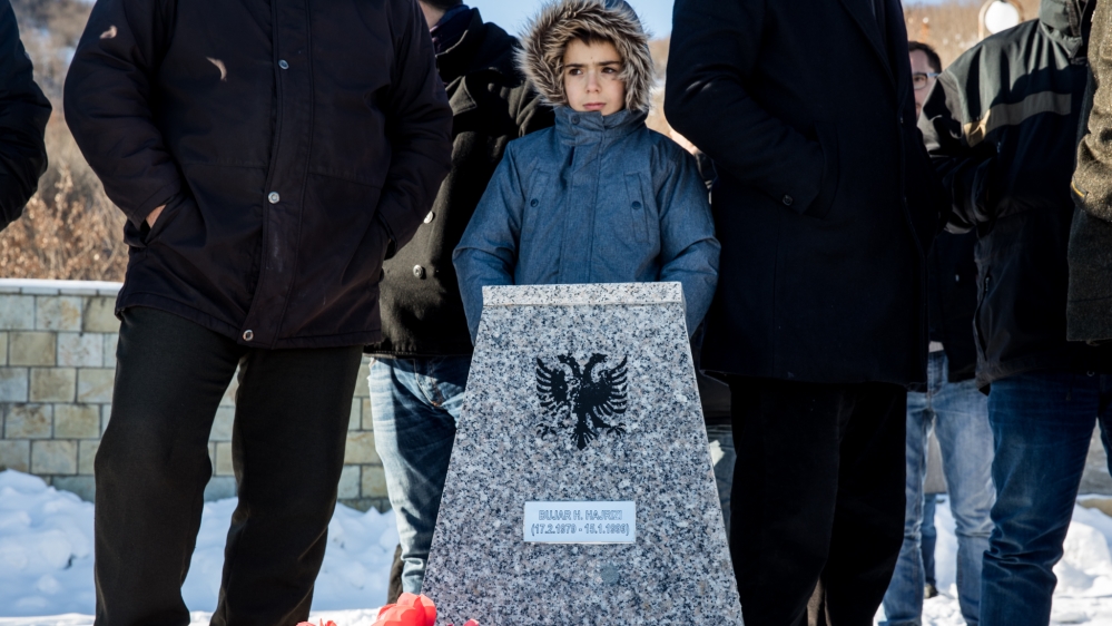 A boy stands at the gravesite of a loved one at Racak [Valerie Plesch/Al Jazeera]