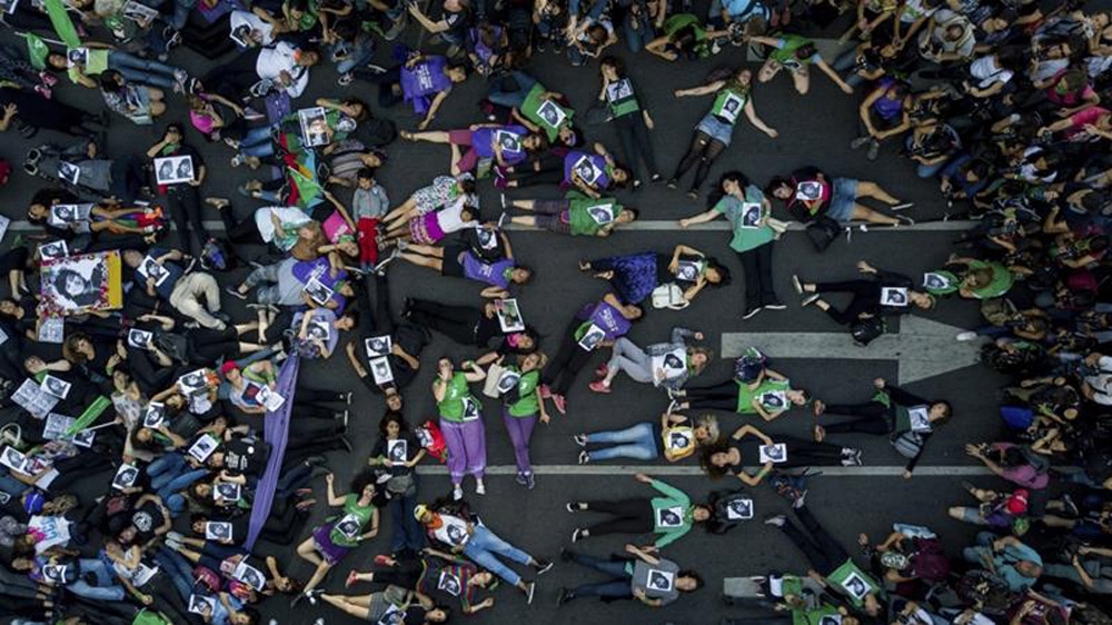 Women around Latin America having been protesting against violence and restrictive abortion laws as part of the #NiUnaMenos movement [File: Tomas F Cuesta/AP Photo]