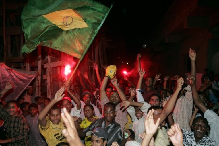 Pakistani soccer fans celebrate the victory of Brazil over Australia in Karachi June 18, 2006. Lyari, one of the oldest and most densely populated parts of the city, is plagued by street crime, drugs,