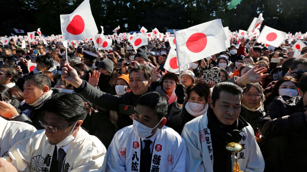 Well-wishers wave Japanese national flags during the appearance of Emperor Akihito at Tokyo's Imperial Palace [Issei Kato/Reuters]