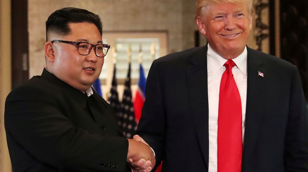 Kim and Trump shaking hands after their summit in June in Singapore [File: Jonathan Ernst/Reuters]