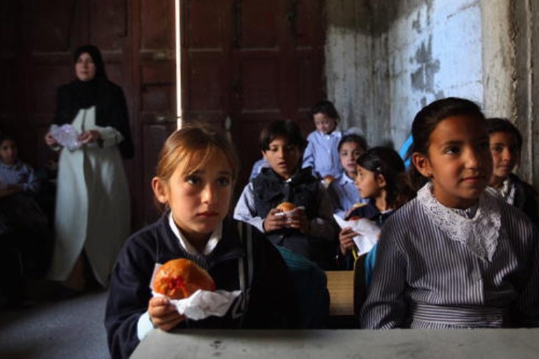 World Food Program Threatened by Rising Food Prices YATTA, WEST BANK - APRIL 21: Palestinian schoolgirls continue with their lessons eating vitamin-enriched snacks provided daily by the WFP