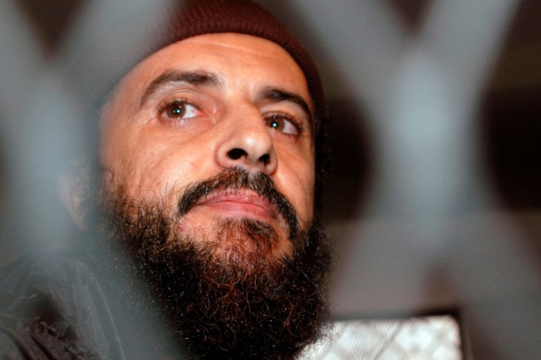FILE PHOTO: Yemeni Islamic militant Jamal al-Badawi looks from behind bars during the first hearing of a Sana''a court of appeals hearing
