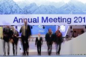 People walk upstairs at the Davos Congress Centre where the annual meeting of the World Economic Forum 2019 takes place, January 20, 2019 [Markus Schreiber/AP]
