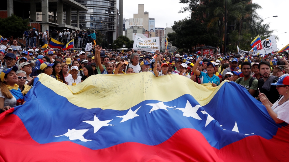 Opposition supporters take part in a rally on January 23 [File: Carlos Garcia Rawlins/Reuters]