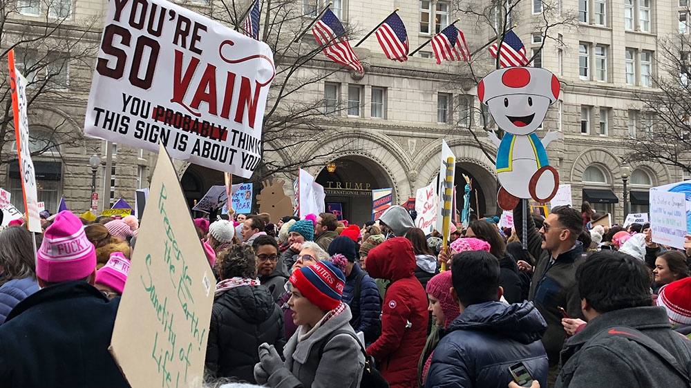Thousands marched past the Trump International Hotel in Washington, DC, chanting 'stop the shutdown, stop the wall' [Laurin-Whitney Gottbrath/Al Jazeera] 