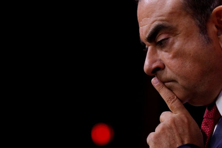 FILE PHOTO: Ghosn, Chairman and CEO of the Renault-Nissan Alliance, reacts during news conference in Paris
