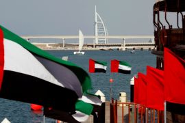 UAE flags fly as the Burj al-Arab luxury hotel is seen in the background during the UAE''s National Day in Dubai