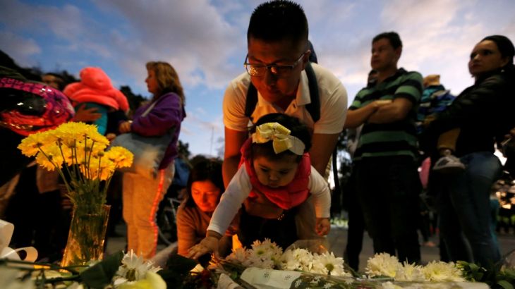 People take part in a candlelight vigil for victims, near the scene of a car bomb explosion, in Bogota