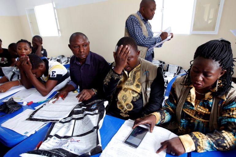 Congo''s Independent National Electoral Commission officials check presidential elections polling stations voting forms at tallying centre in Kinshasa