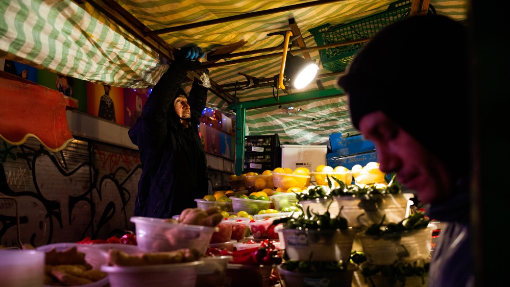 Two men from Cyprus set up their vegetable stall [Jose Sarmento Matos/Al Jazeera]