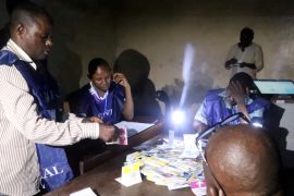 FILE PHOTO: Agents of Congo''s National Independent Electoral Commission (CENI) count casted ballot papers after election at a polling station in Kinshasa
