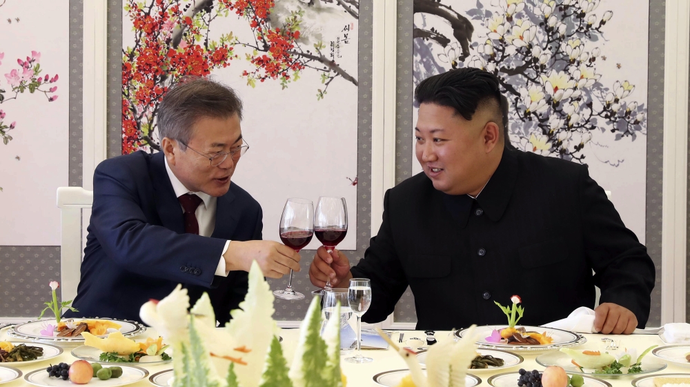 South Korean President Moon Jae-in, left, holds a toast with North Korean leader Kim Jong Un during a luncheon at the Samjiyon guesthouse in North Korea at their summit last September [Pyongyang Press Corps Pool/AP]