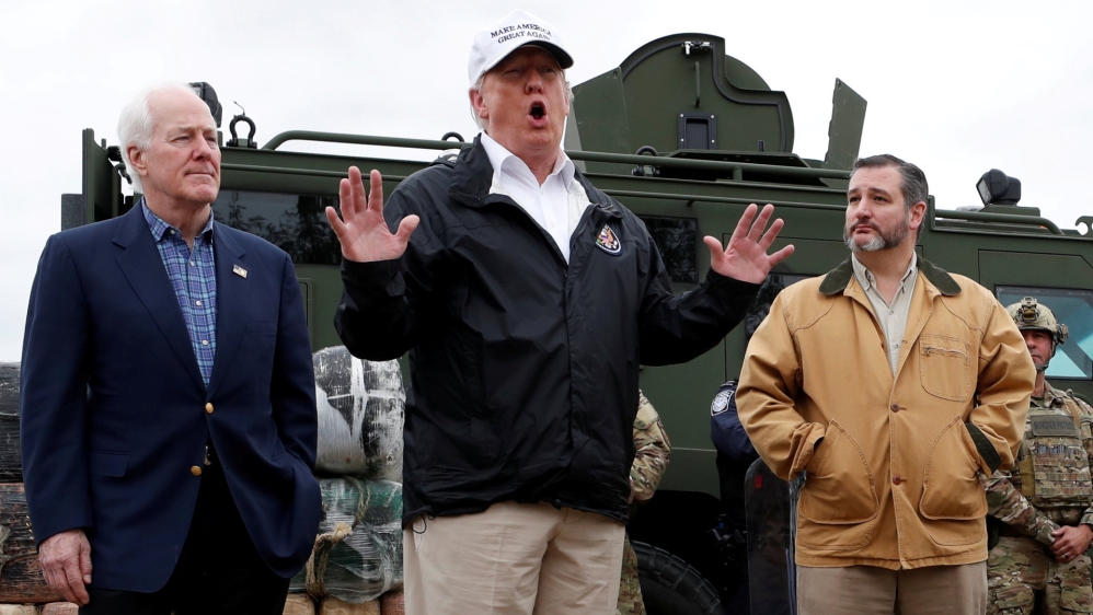 Trump speaks to reporters as he visits the banks of the Rio Grande River with Senators John Cornyn and Ted Cruz and US Customs and Border Patrol agents during his visit to the US-Mexico border [Leah Millis/Reuters] 