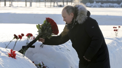 Russian President Vladimir Putin places flowers at the Piskaryovskoye cemetery [Mikhail Klimentyev via AP Photo]