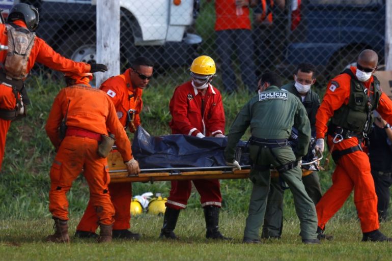Members of rescue team carry a body recovered after a tailings dam owned by Brazilian mining company Vale SA collapsed, in Brumadinho