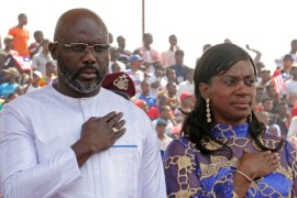 Liberia's President Weah stands with his wife Clar during his swearing-in ceremony at the Samuel Kanyon Doe Sports Complex in Monrovia on January 22, 2018 [File: Thierry Gouegnon/Reuters]