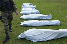 A soldier guards the bodies of some of the16 members of Colombia''s largest rebel army, the Revolutionary Armed Forces of Colombia, or FARC, who were killed by Colombian soldiers, Sunday, April 20, 20