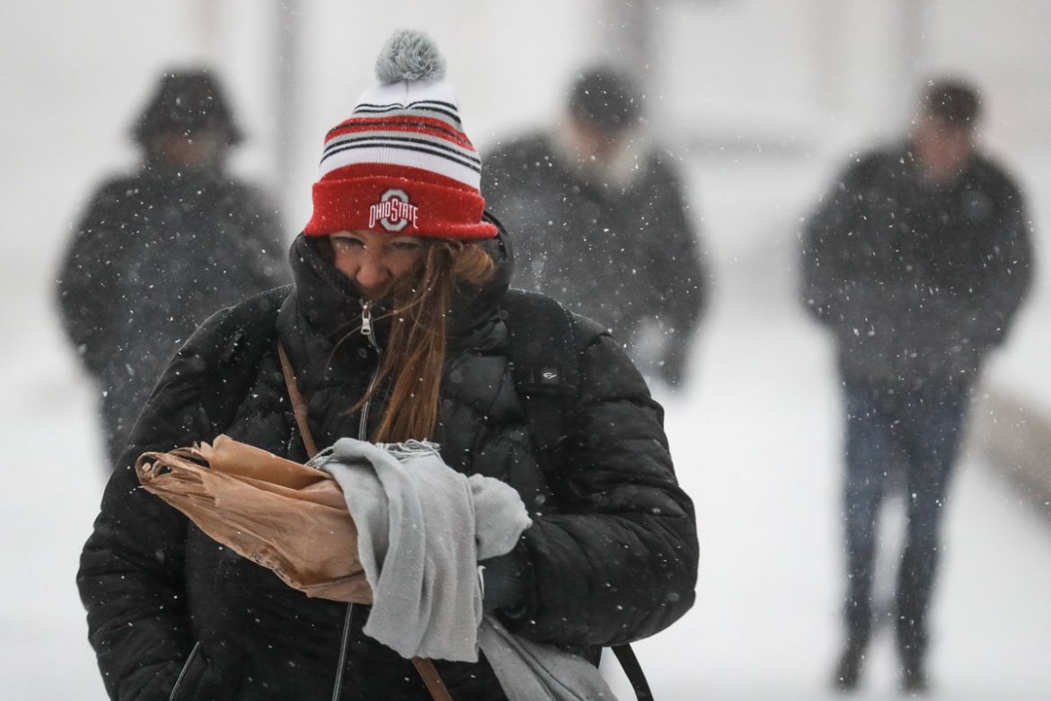 Commuters braves the wind and snow in frigid weather, Wednesday, Jan. 30, 2019, in Cincinnati. The extreme cold and record-breaking temperatures are crawling into a swath of states spanning from North
