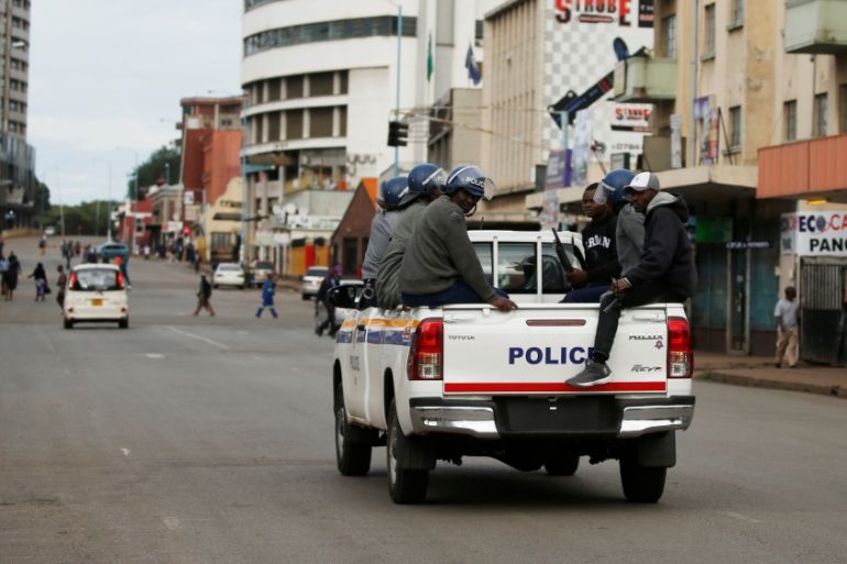 Zimbabwe Police officers are seen driving along the streets of Harare