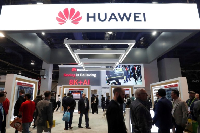 FILE PHOTO: Attendees pass by a Huawei booth during the 2019 CES in Las Vegas