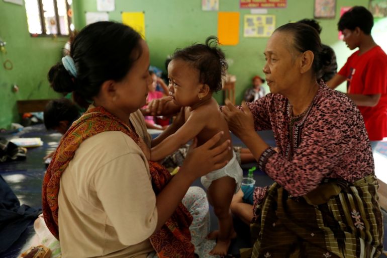 A child affected by the tsunami receives an aromatherapy treatment to cure a flu inside a school used as a shelter in Labuhan