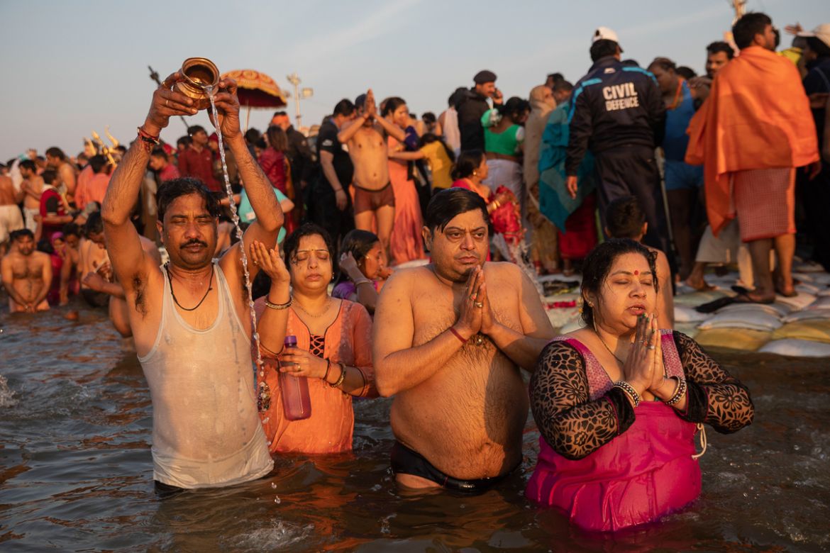 Hindu devotees take a dip on auspicious Makar Sankranti day during the Kumbh Mela, or pitcher festival in Prayagraj, Uttar Pradesh state, India, Tuesday, Jan.15, 2019. The Kumbh Mela is a series of ri