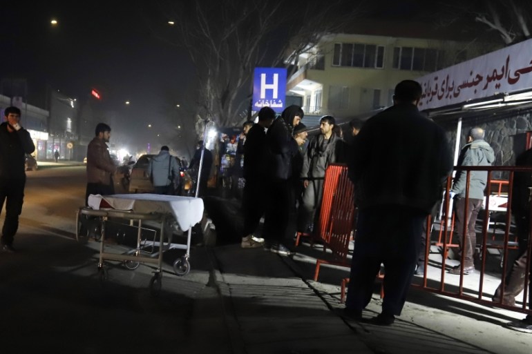 Afghan health workers wait to receive incoming wounded people outside the emergency hospital after a truck bomb blast targeted Green Village camp belong to foreigners in capital Kabul, Afghanistan