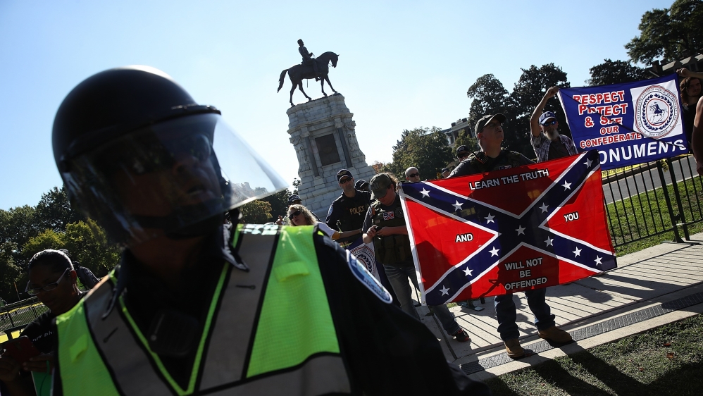
Police keep protesters in support of retaining the statue of Confederate General Robert E Lee separated from counterprotesters in September 2017 in Richmond, Virginia [Win McNamee/Getty Images/AFP]
