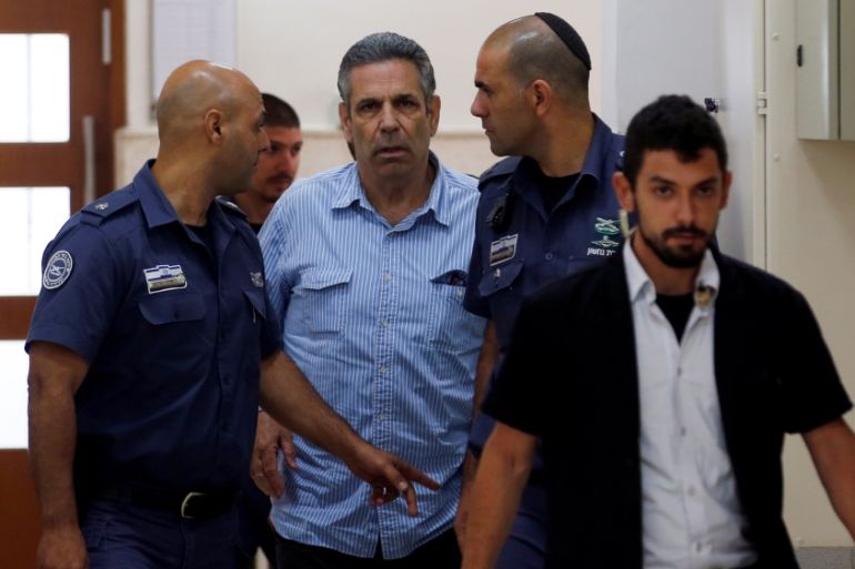 Gonen Segev, a former Israeli cabinet minister indicted on suspicion of spying for Iran, is escorted by prison guards as he arrives to court in Jerusalem
