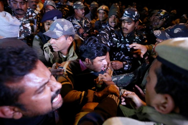 Protesters scuffle with police during a protest against state government for allowing two women to defy an ancient ban and enter the Sabarimala temple, in New Delhi