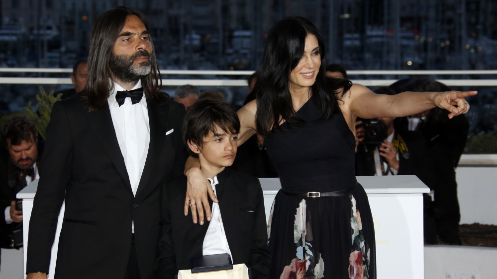 Nadine Labaki, composer Khaled Mouzanar, and cast member Zain al-Rafeea pose with the Jury Prize award for the film Capernaum at the 71st Cannes Film Festival [File: Jean-Paul Pelissier/Reuters]