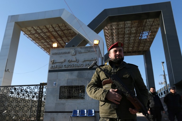 A member of Palestinian security forces loyal to Hamas stands guard at the gate of Rafah border crossing, in the southern Gaza Strip January 7, 2019