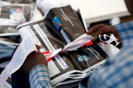 Man holds a bag containing voting materials at CENI tallying centre in Kinshasa