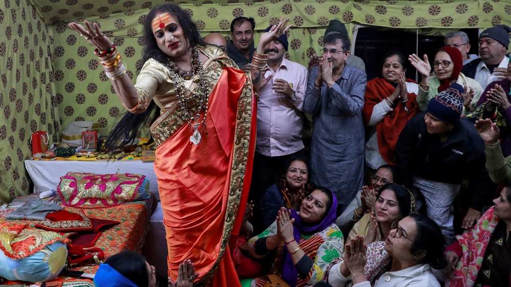 Lakshmi Narayan Tripathi of the 'Kinnar Akhara' congregation for transgender people dances and sings with followers at Kumbh [Danish Siddiqui/Reuters]