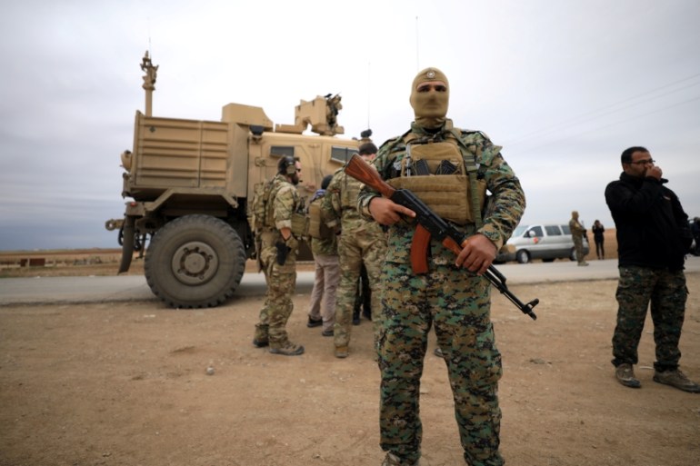 Syrian Democratic Forces and U.S. troops are seen during a patrol near Turkish border in Hasakah