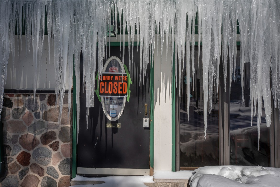 Icicles hang in front of a door at a bar in Mequon, Wis. Wednesday, Jan. 30, 2019 as temperatures were sub-zero and wind chills were -50 degrees. (AP Photo/Jeffrey Phelps)