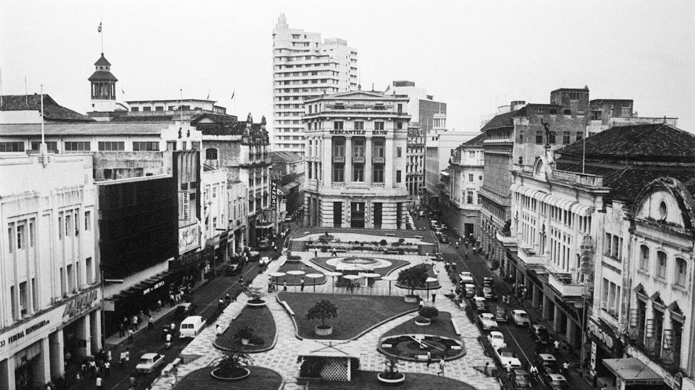 
Singapore has long embraced its colonial past and the name 'Raffles' adorns schools, businesses and streets. Raffles Place, the centre of the city's financial district, in 1968. [File/AP Photo]
