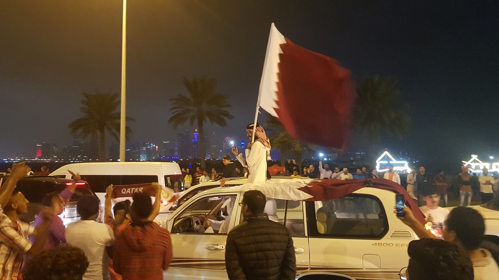 Qatari nationals and migrant workers in Doha celebrate Qatar's semi-final win [Ted Regencia/Al Jazeera]