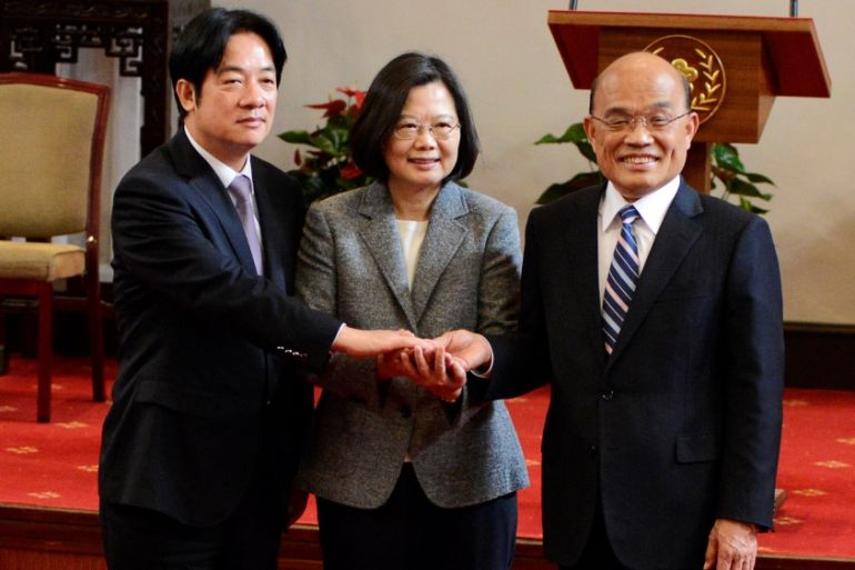 Former premier William Lai, Taiwan President Tsai Ing-wen and new premier Su Tseng-chang join hands after a news conference in Taipei