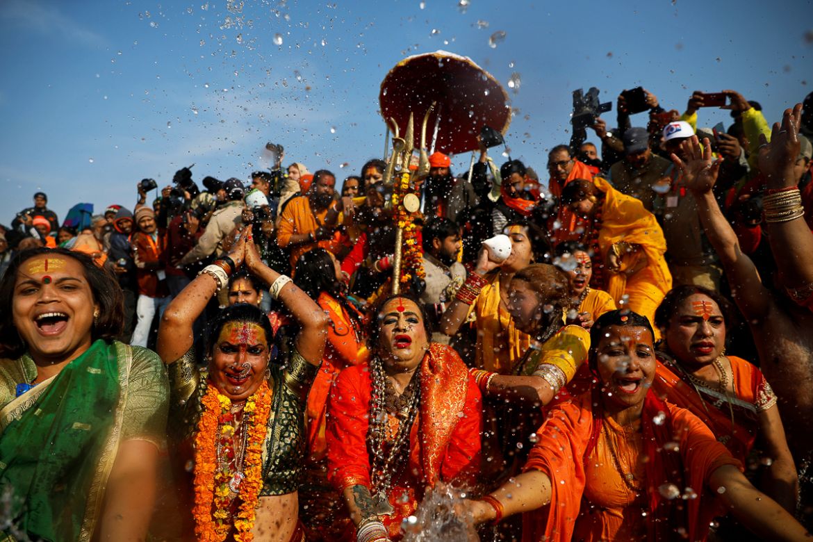 Lakshmi Narayan Tripathi (C), chief of the "Kinnar Akhada" congregation for transgender people and other members take a dip during the first "Shahi Snan" (grand bath) at "Kumbh Mela" or the Pitcher Fe
