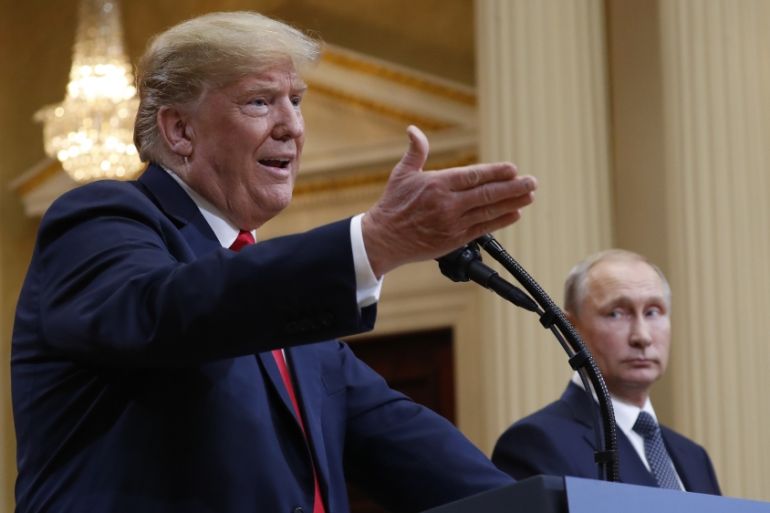 U.S. President Donald Trump, left, gestures while speaking as Russian President Vladimir Putin
