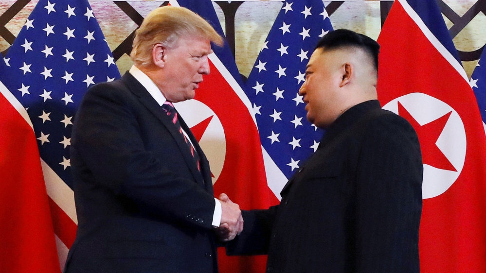 Trump and Kim Jong Un shake hands before their one-on-one chat [Leah Millis/Reuters]