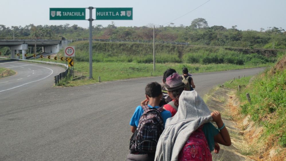 Kenia Marisol Alvarado, her husband and son, and another family walk into Huixtla after a truck driver dropped them off at the highway turn-off [Sandra Cuffe/Al Jazeera]
