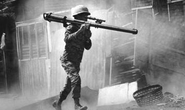 A South Vietnamese soldier with a bazooka advances along a Saigon Street in this February 2, 1968 photo [File: AP]