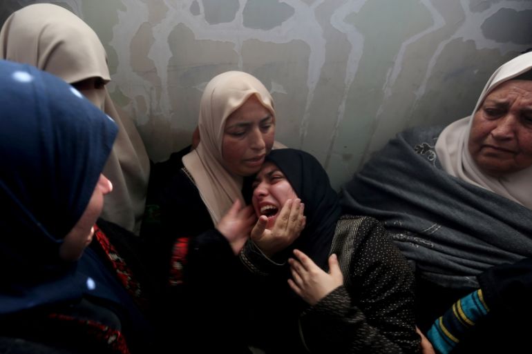Relatives of Palestinian teen Hassan Shalabi, 14, mourn during his funeral in the central Gaza Strip