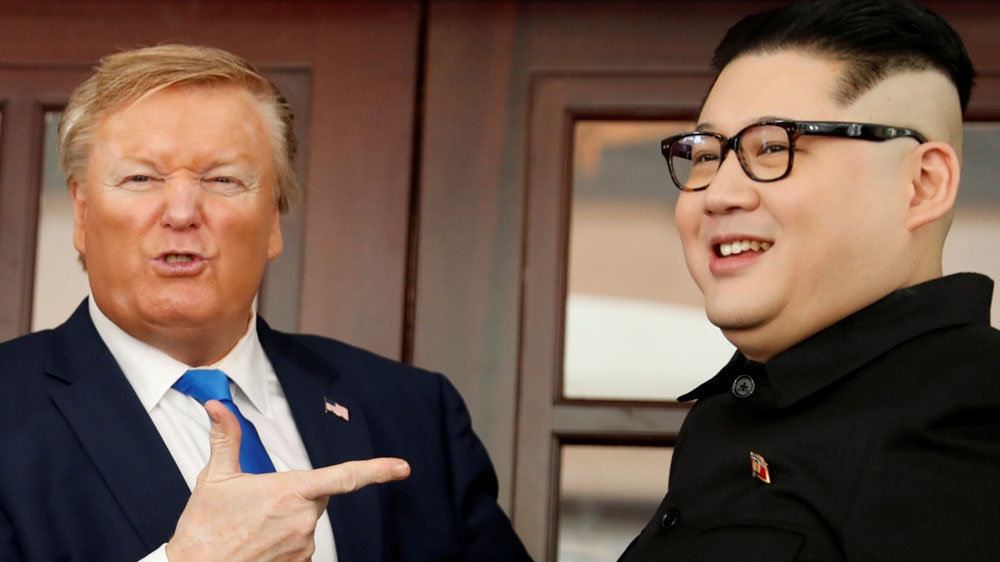 Billionaire Donald or Russell White, who is impersonating Trump, and Howard X, a Kim lookalike, pose for a photo at Hanoi's Metropole Hotel [Jorge Silva/Reuters]